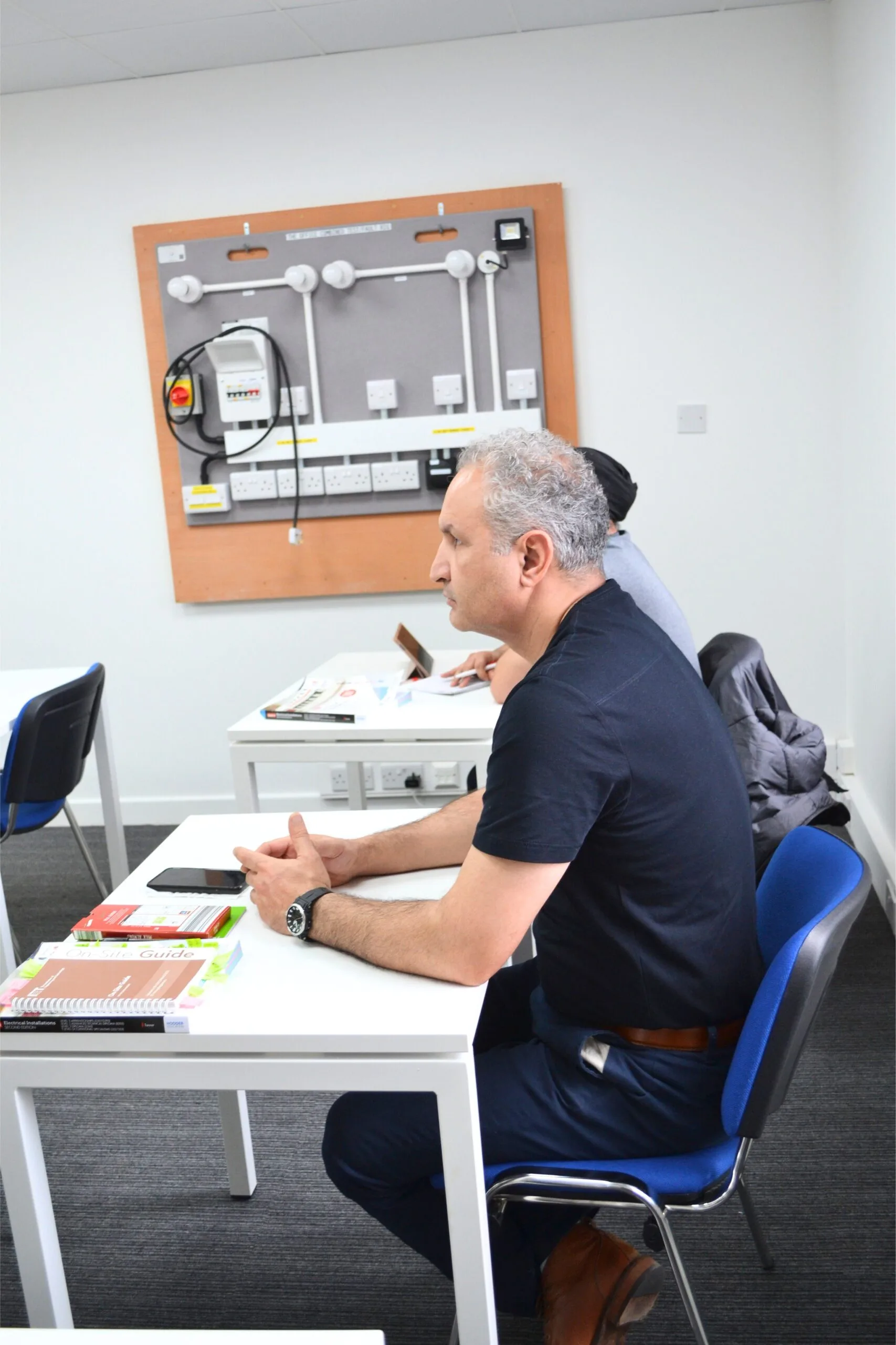 Students learning in a Level 3 Electrical Installation Course classroom at Elec Training