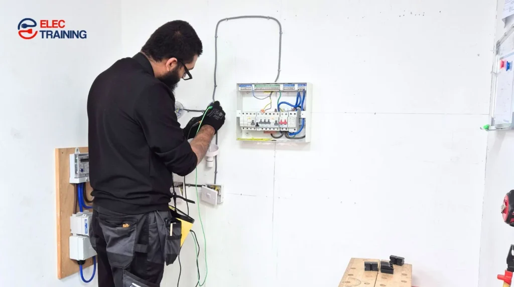 Adult learner completing hands-on electrical training on a consumer unit at Elec Training.