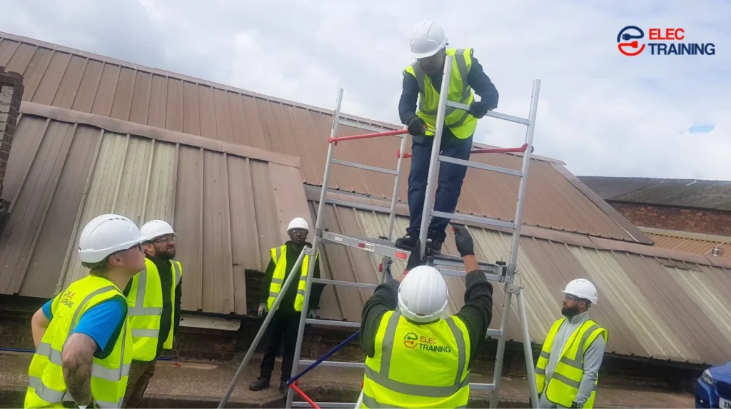 UK electrician in PPE on construction site documenting electrical work for NVQ training