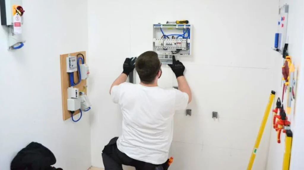 Young apprentice in UK construction training environment learning vocational skills