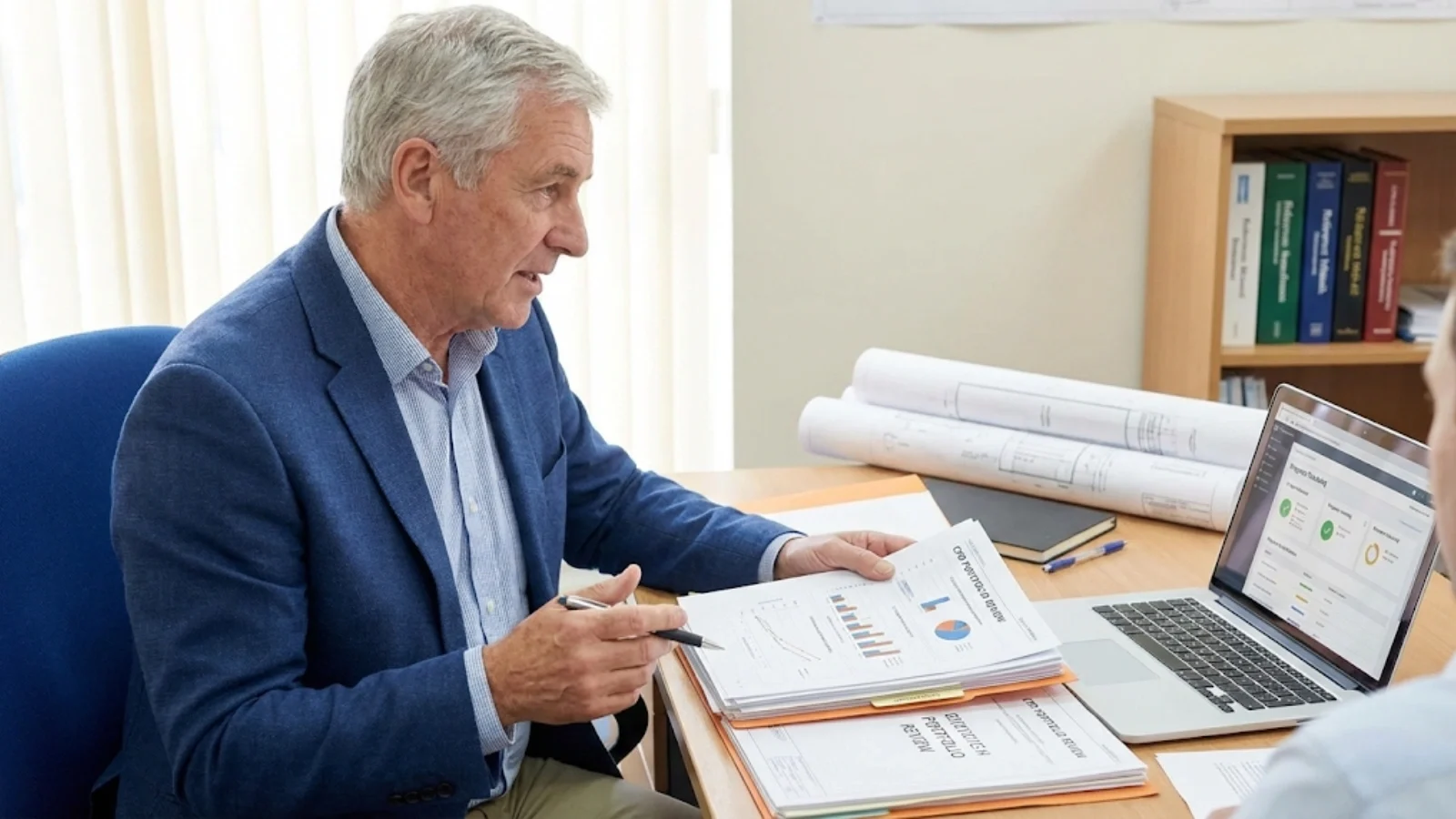 An experienced practitioner reviewing professional development records, representing the transition from hands-on engineer to trusted CPD advisor within the UK engineering sector